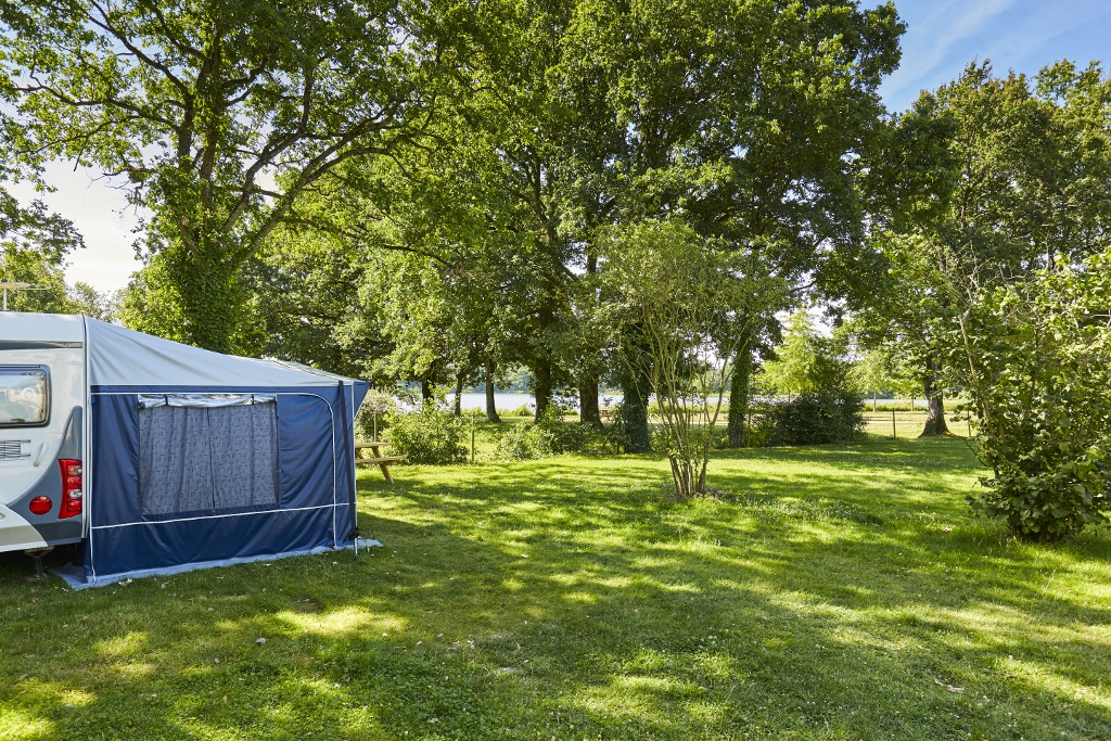 Forfait Privilège (tente, caravane ou camping-car / 1 voiture / électricité 16A). Grand emplacement avec vue sur lac