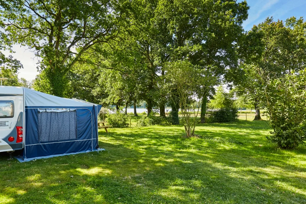 Forfait Privilège (tente, caravane ou camping-car / 1 voiture / électricité 16A). Grand emplacement avec vue sur lac